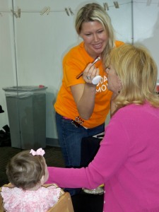 Amanda from Eve Pearl Studio puts final touches on a glam-ma as she holds her granddaughter's hand