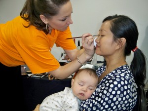 Tracy from Eve Pearl Studio putting a little makeup on a deserving Mommy